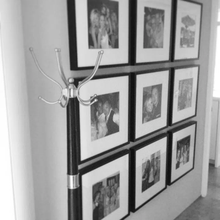 A series of 9 photographs framed in a grid format on a white wall. The inteiror designers wanted to create impact when entering this property. The entrance is accessed by a private elevator; visitors get an instant introduction and insight into the owners of this property.