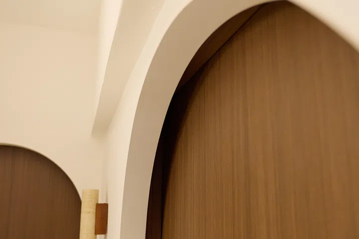 A closer look reveals how the curved facade frames the original HDB door.