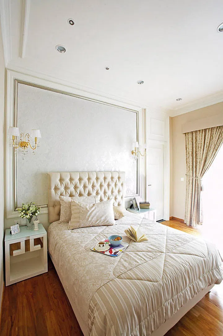While many associate the classical décor style with gaudy furniture and garish colours, it can also be expressed in a variety of subdued elements and creamy tones like in this bedroom. Subtle wall paneling and a plush headboard is sometimes all you need to pay homage to the timeless style.