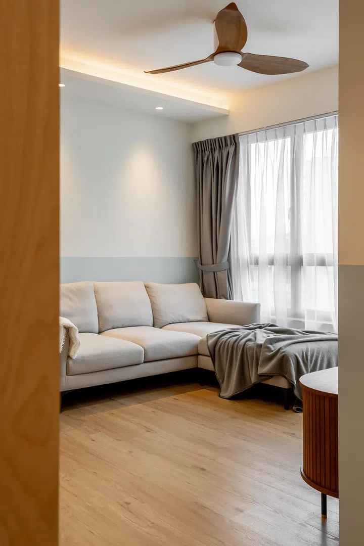 A simple three-seater white sofa anchors the living room in Mr and Mrs Chua’s 4-room BTO in Tampines.