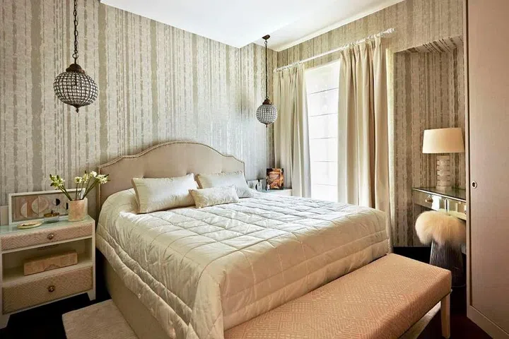 . The cream and beige of this bedroom might look bland if not for the mix of textures, which makes the space more cosy and inviting. The glass lamps and mirrored dressing table add just the right touch of shine and richness to the contemporary space. Design: E&A Interiors