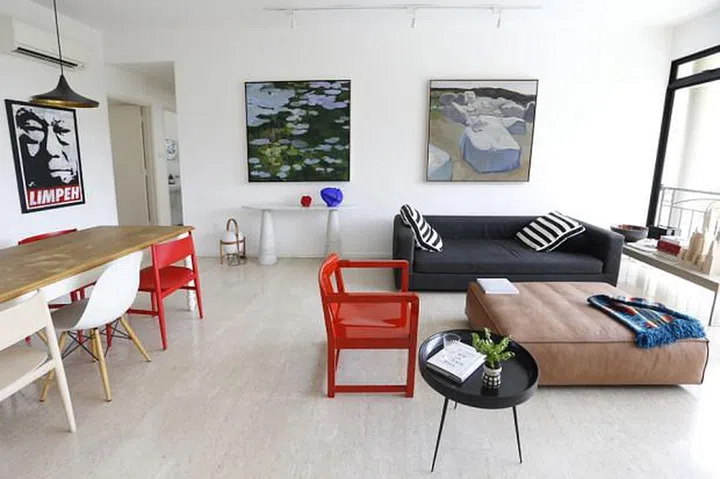 Living room in Gallerist Lim Ju Lynn's all-white 3-bedroom Bukit Timah condominium filled with art.