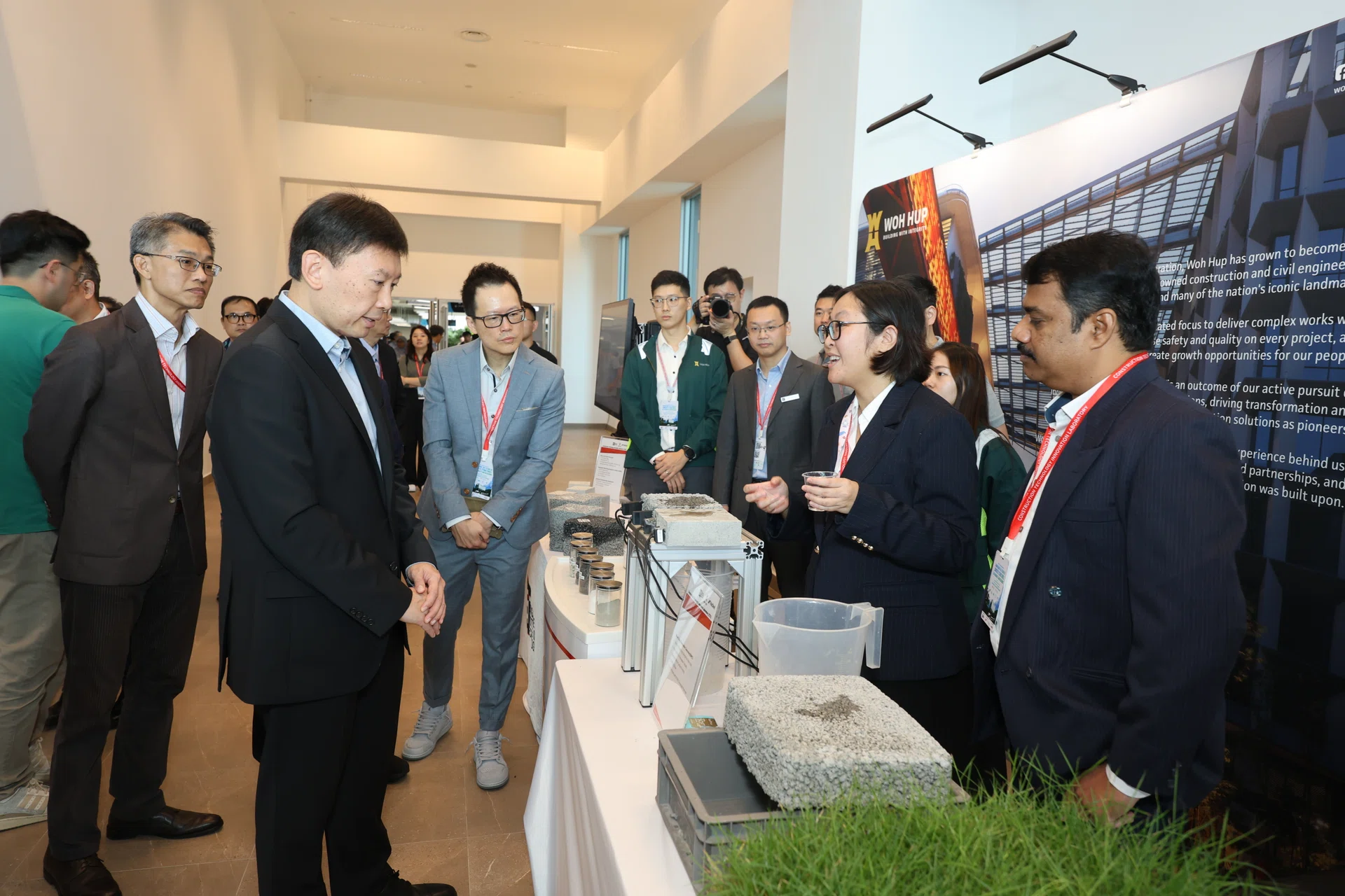 Minister for National Development Mr Chee Hong Tat viewing Woh Hup and SIT’s Steel Slag Porous Concrete Pavement demonstration.