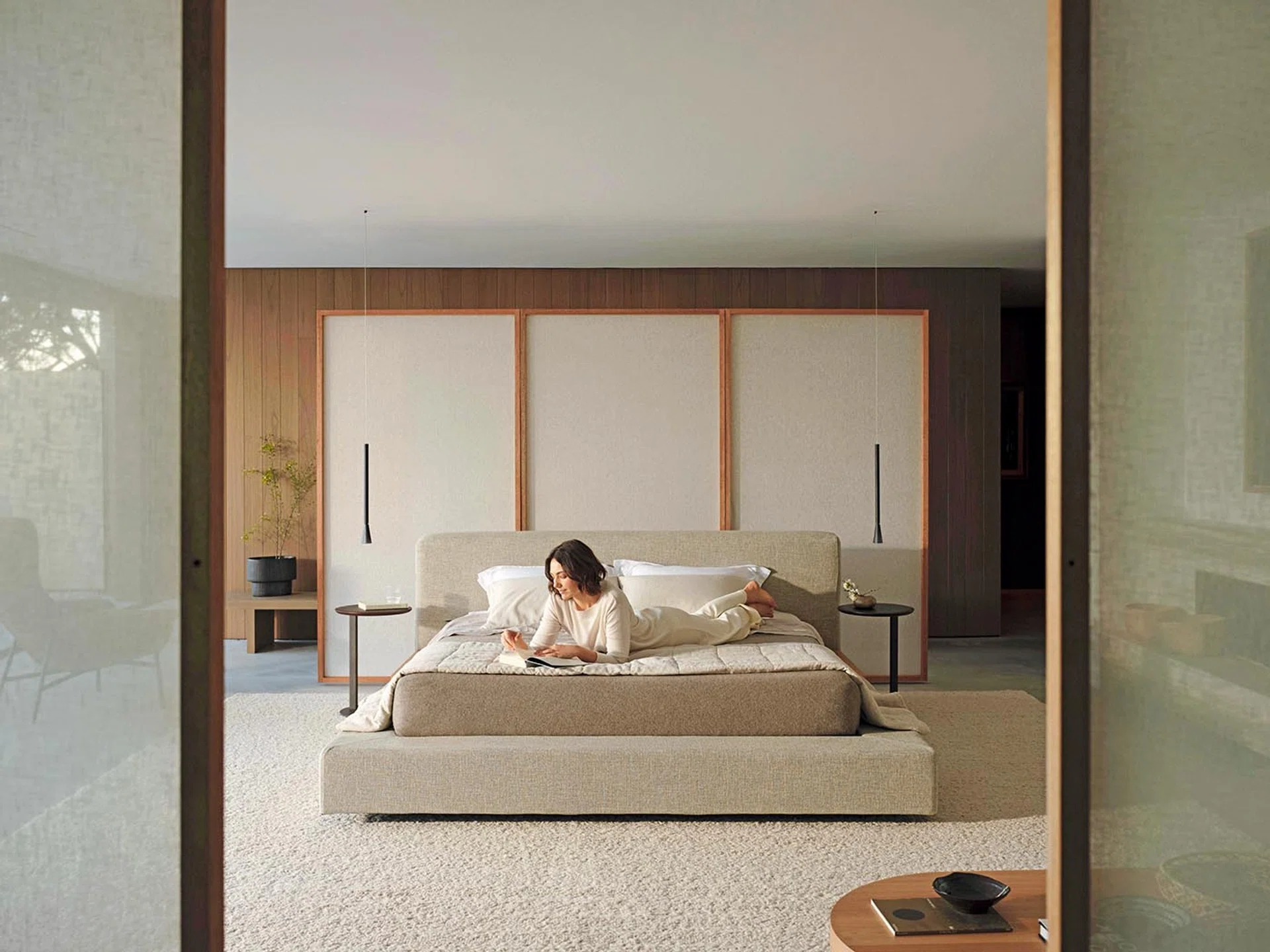 Female model posing on a King Living Jasper Bed.