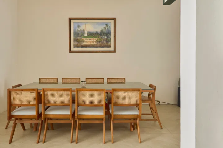 A long dining table supports a daily ritual of shared, no-phone dinners centred on conversation and connection.