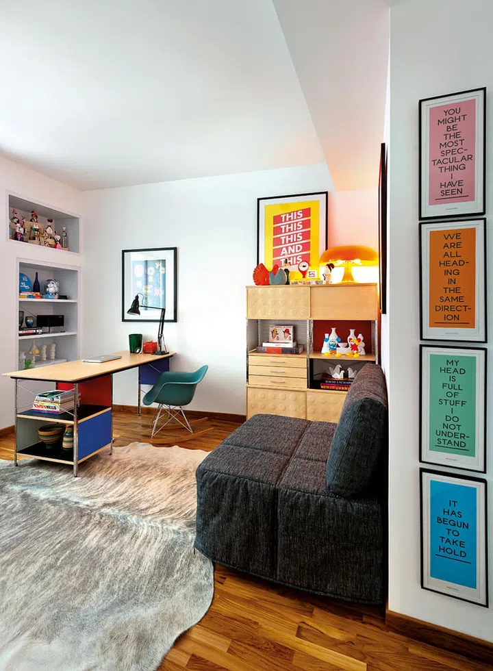 The study is done up in a vibrant manner, with plenty of soft fabrics and colourful posters.