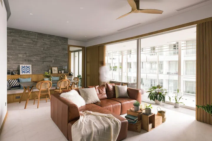 Wood sliding doors open to reveal a balcony and view of the neighbouring condominium units in this 1,900 sq ft 3-bedroom condominium in Sentosa.