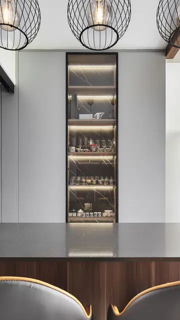 Glass display kitchen cabinet positioned next to the kitchen island in a 3 plus 1 bedroom apartment in Waterfront Key condominium along Bedok Reservoir Road.