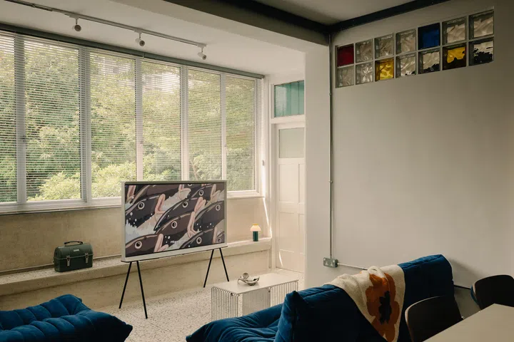 The Living Room with its low-to-the-ground furniture and green street views.