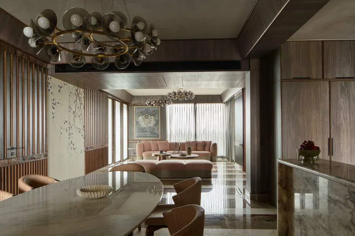 Muted colours set the scene across the living and dining areas in this Kolkata home by Pooja Bihani. 