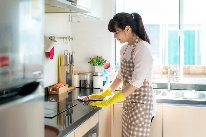 Domestic helper cleaning the kitchen