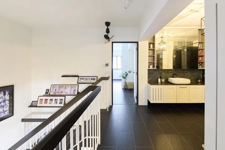The second floor's common bathroom's wash basin and vanity was extended into the stairwell landing space in a HDB Executive Maisonette along Woodlands Drive for a family of 5.