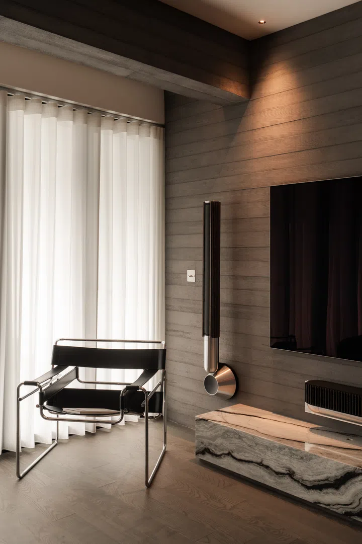 A Wassily Chair by Marcel Breur from Knoll sits in the top left corner of his living room.