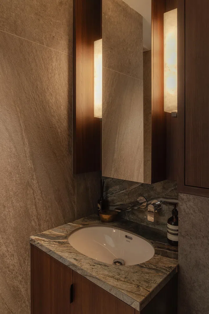 Soft lighting highlights the natural variations of the stone and marble surfaces.
