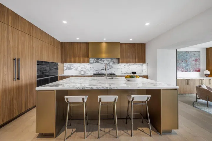 The chef's kitchen sports a marble-topped island.