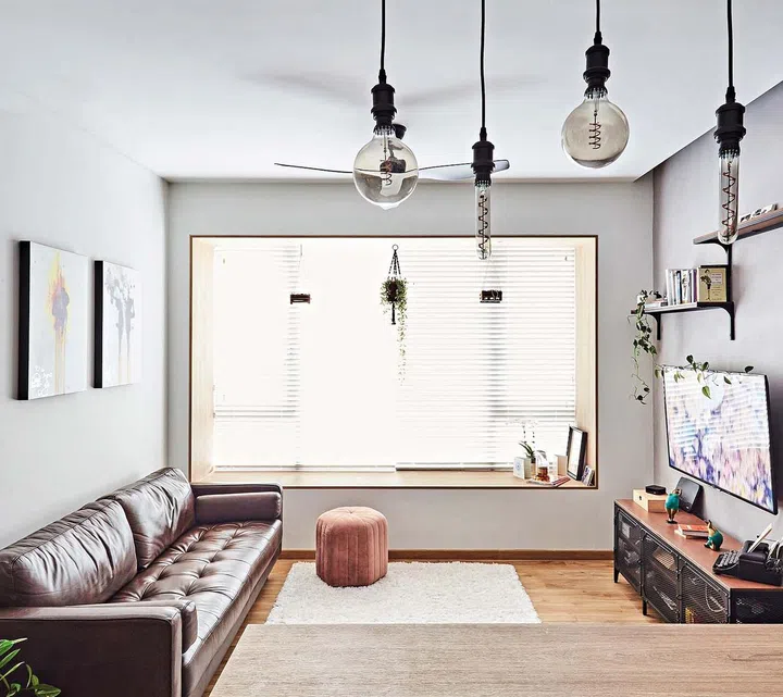 Homeowner Ingrid Liew enjoying a cuppa in her chic industrial-style open kitchen.