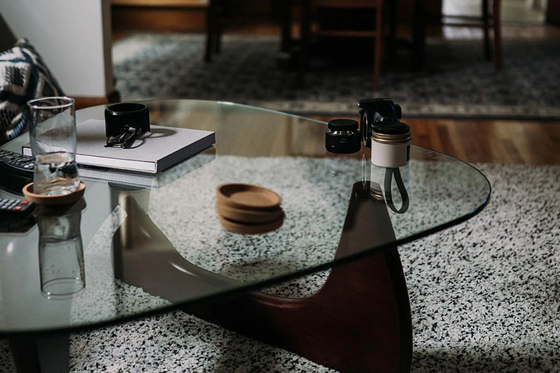 Tempered glass coffee table in a living room with carpet.