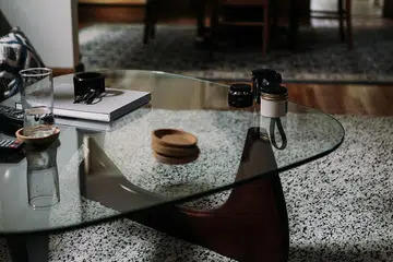 Tempered glass coffee table in a living room with carpet.