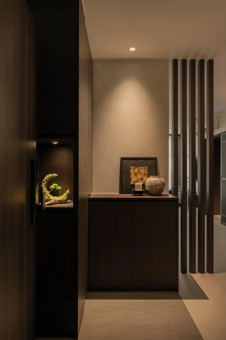  At the foyer, a preserved bonsai and curated objects introduce the home’s philosophy of calm and balance.
