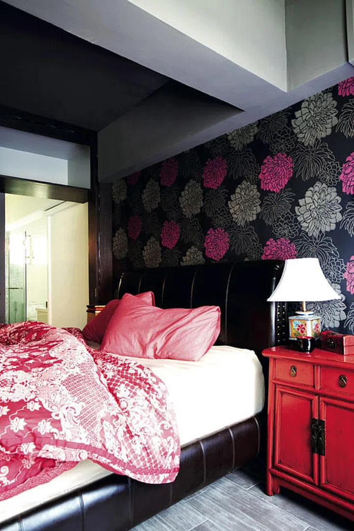 Feminine reds and pinks are toned down by dark browns in the master bedroom.