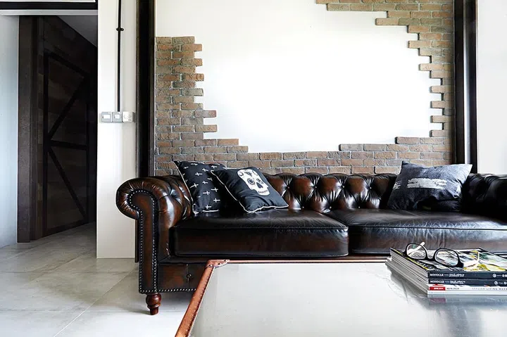 [Renovation costs: $45,000] The brick-like feature wall was deliberately left unfinished to create the illusion that “the wall was hacked halfway”, says the designer.