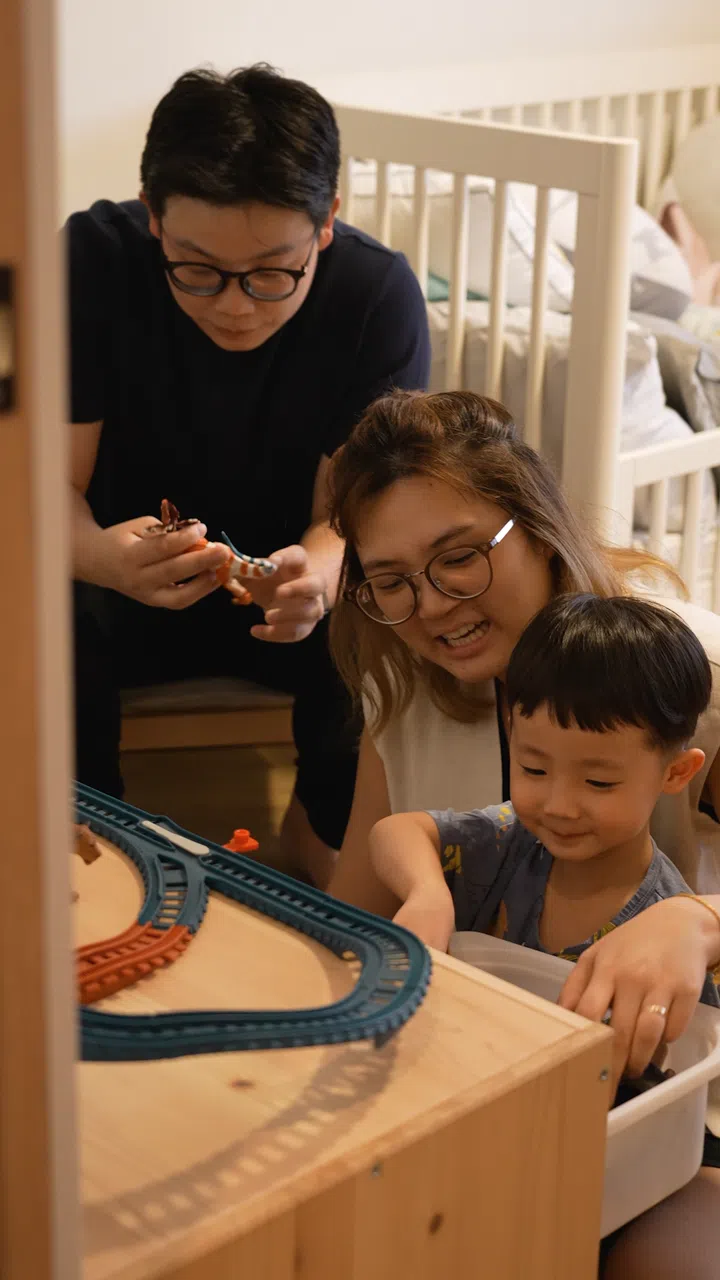 Interior designer Cedrick Law and wife Chua Tse Lyn poses for a picture with their child.