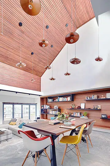 The double-volume ceiling enabled the arrangement of pendant lamps from Light + Form Concepts to star as the centrepiece above the Miniforms Gustave dining table from Xtra. Flowers from Poppy Flora Studio. Tableware from Galanga Living.