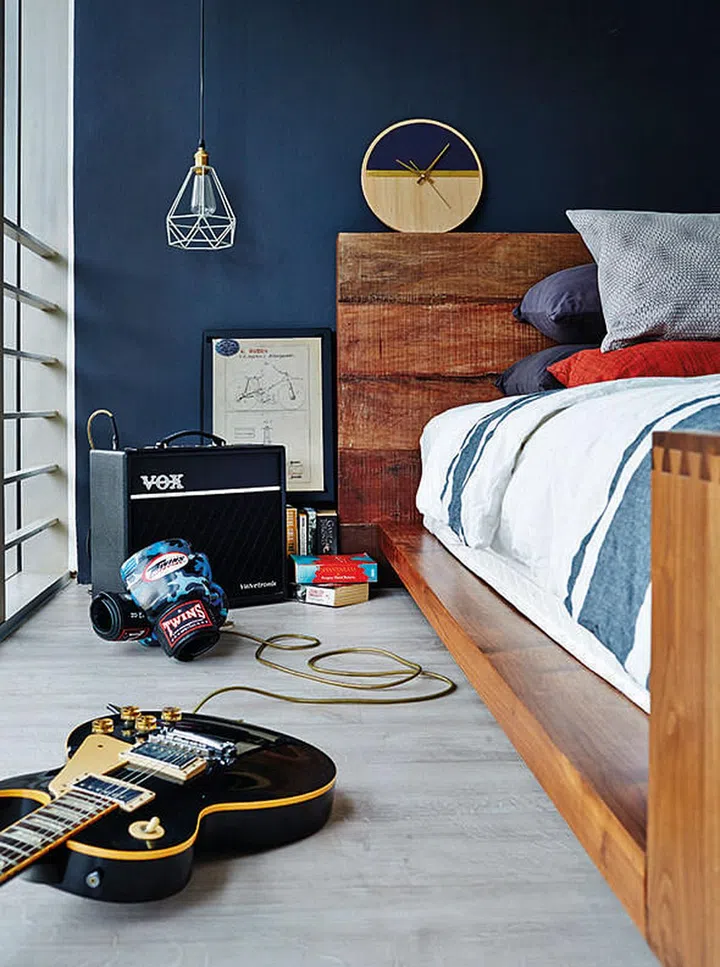 The bedroom - with its moody blue wall - has a warm, eclectic feel. Desmond says the rustic-looking bed frame, from Crate & Barrel, is his favourite piece of furniture.