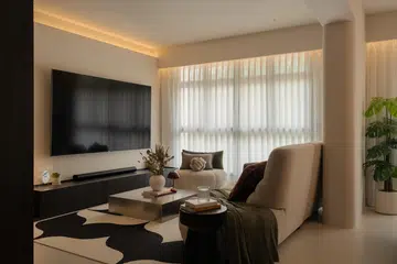 A modular, curved sofa sourced locally anchors the living room, chosen for comfort, flexibility, and long-term use.