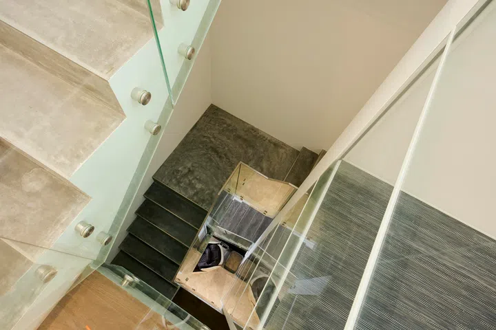 Viewed from above, the stair and lift work together to maintain visual continuity across levels and keep the interior feeling open rather than compartmentalised.