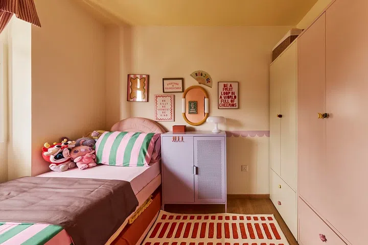 Soft pink tones, cheerful hues and fun details create a bedroom designed to grow alongside its young occupants.
