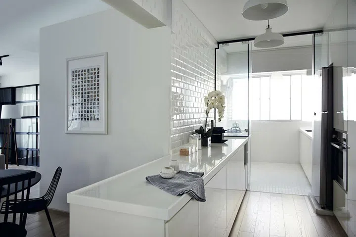 Walls were demolished to open up the kitchen, which has a gallery layout with a bright and airy feel. Tableware and linen towel, both from stylodeco.com.