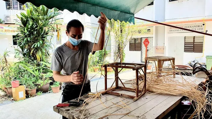 Owner of Chun Mee Lee Rattan Furniture at work.