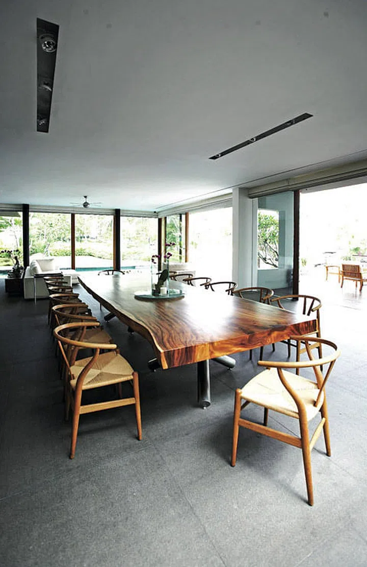 A 4-metre-long suar dining table dominate the dining room in this 2-storey bungalow in Sentosa Cove.