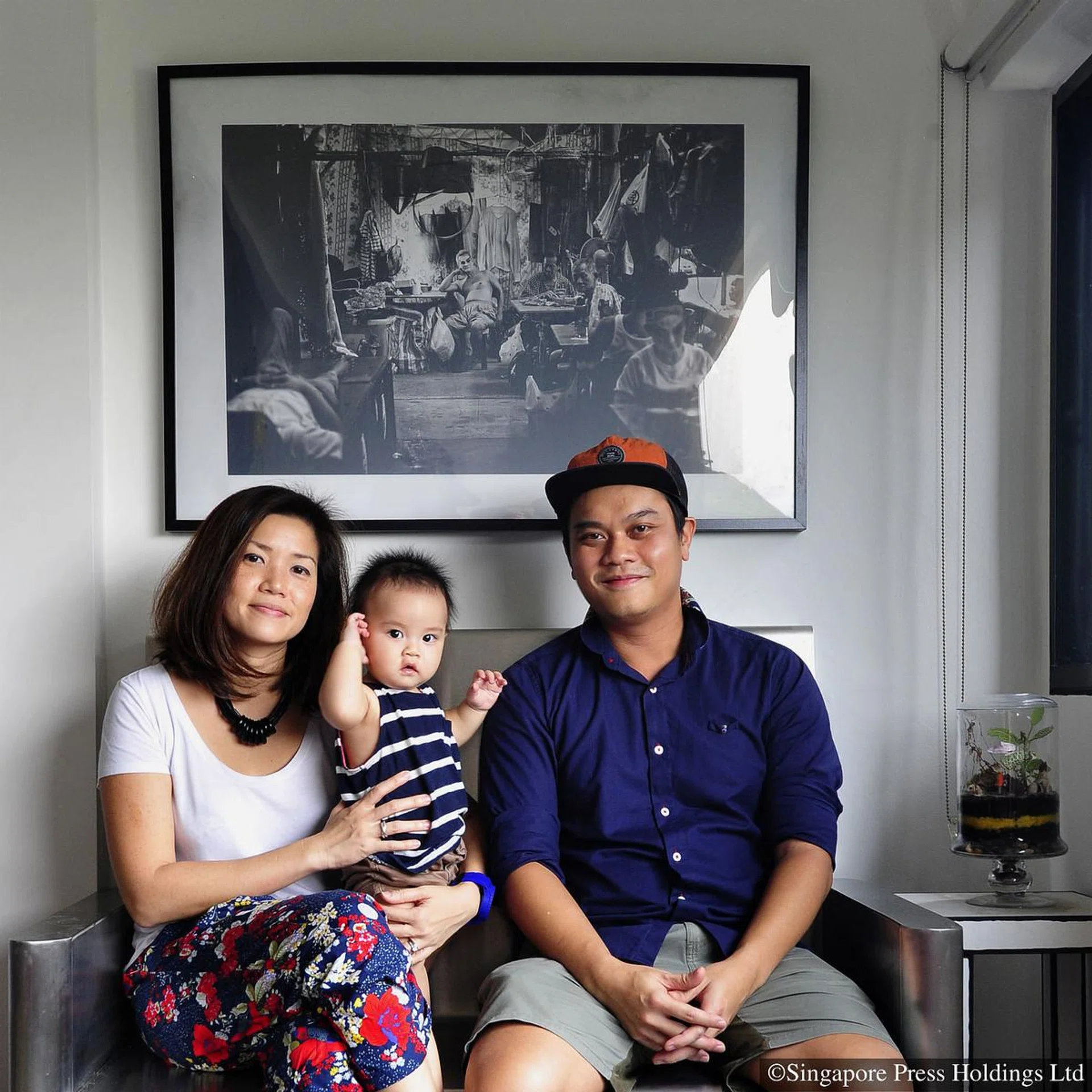 Ms Pearl Leong and her husband Jay Sim poses for a picture with their son, Jax, in their HDB Maisonette in Clementi in 2014.