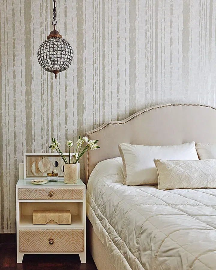 Custom-made bedside tables, with inset George Spencer fabric panels, add a luxurious touch to the master bedroom.