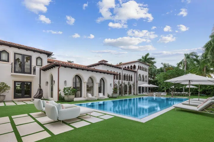 A 50-feet pool adorns the palm-lined grounds.