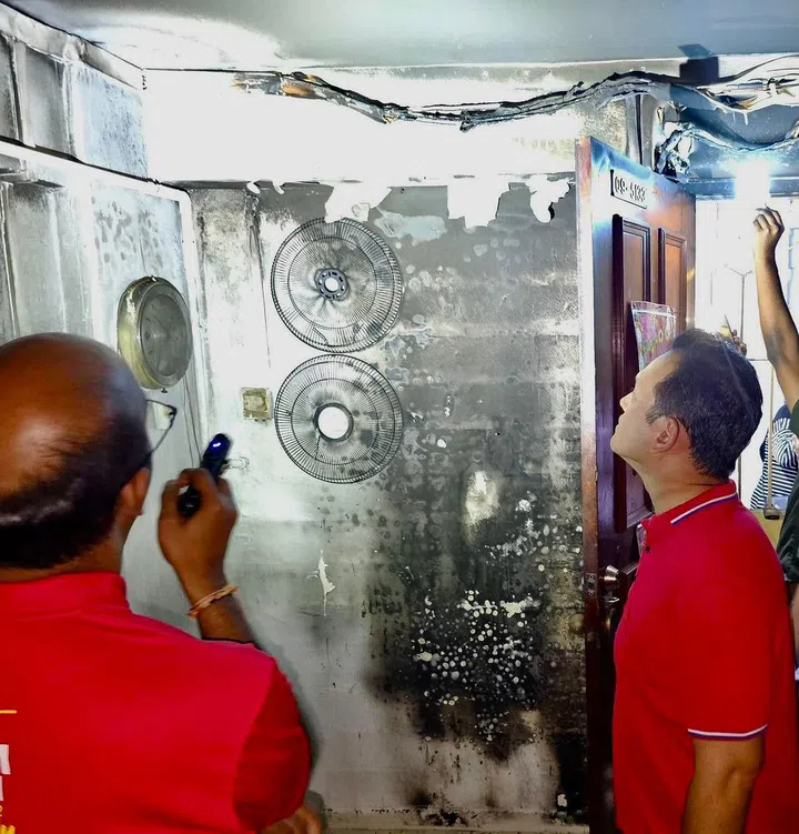 Photo of MP Zaqy Mohamad surveying burnt residue in a HDB flat at Block 3 and 4 Marsiling Road after a fire on 15 Feb 2024. Photo Zaqy Mohamad Facebook