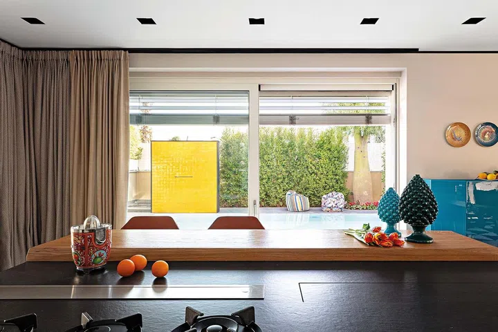 Kitchen by TM Italia. Blue Bramante, cabinet by Cassina.