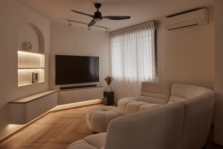 Concealed lighting highlights the bespoke carpentry, transforming the living room into a cosy retreat after dark.