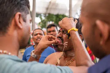 SINGAPORE - Feb 08, 2020: Thaipusam is a religious celebration by devotees. Its highlight is a barefoot walk of devotees carrying milk pots and dancing with prickly kavadis.