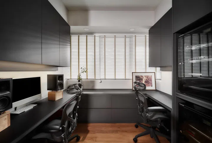 Within the master suite, the study offers a dedicated workspace for two, with concealed storage and dark-toned joinery that create a focused, uncluttered environment.