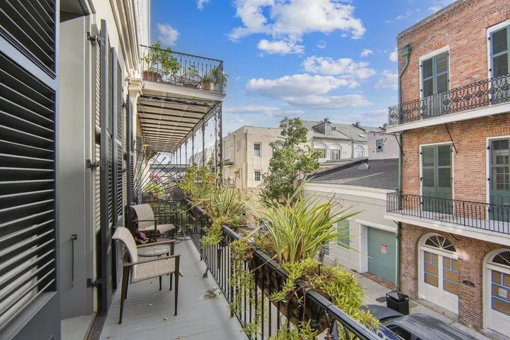 Multiple balconies overlook the street and the courtyard.
