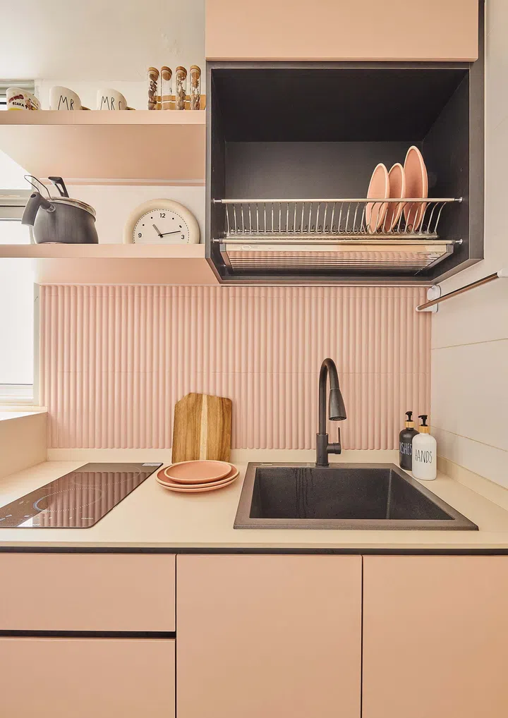 Charming pastel pink kitchen with clean lines and soft tones, offering a gentle contrast to the rest of the home’s neutral palette.

