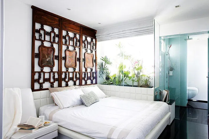 Plants and open, connected spaces evoke free-flowing energy and harmony in the bedroom.