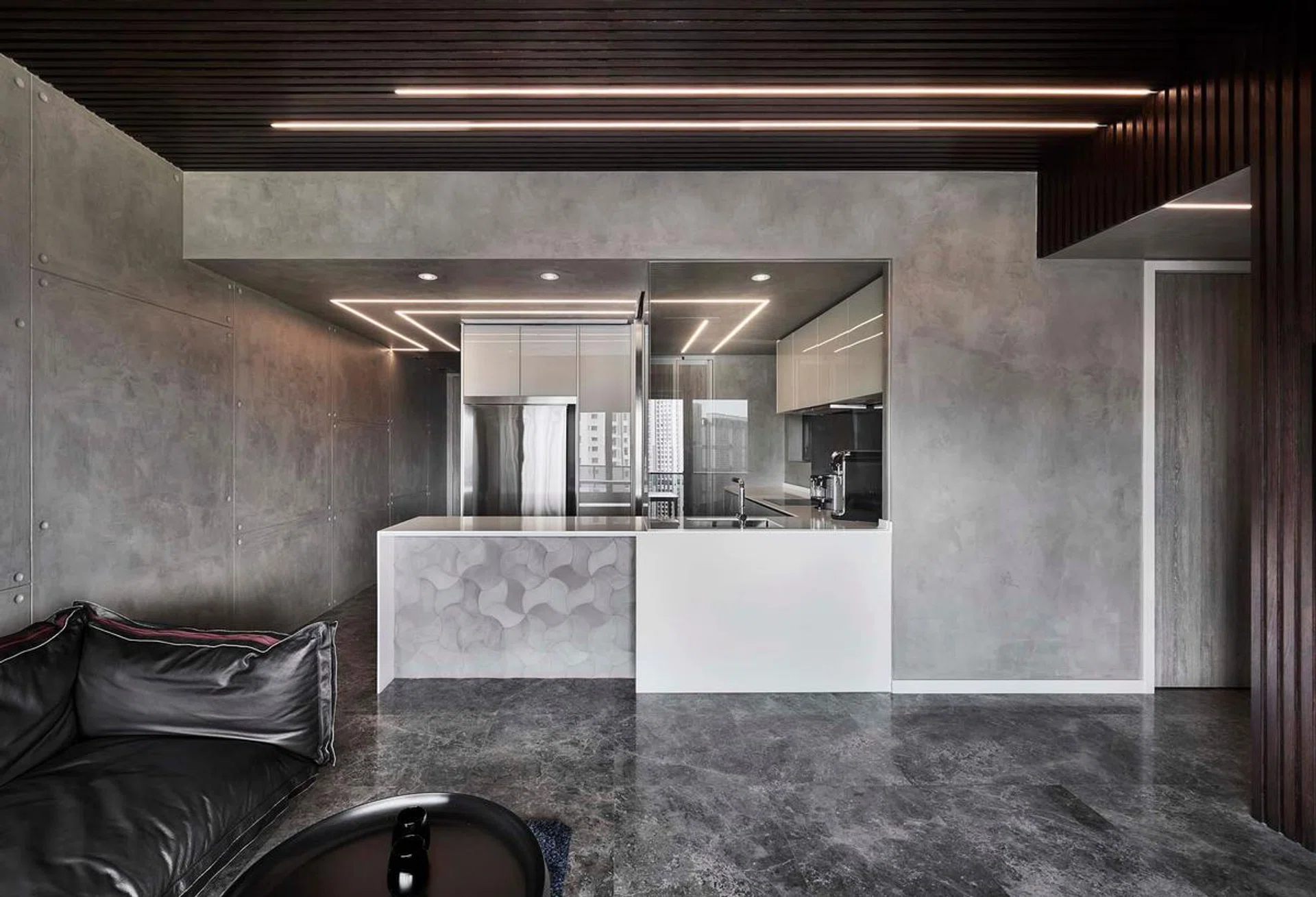 Concrete kitchen island in this all black and white 1,184 sq ft 4-bedroom condo in Queenstown.