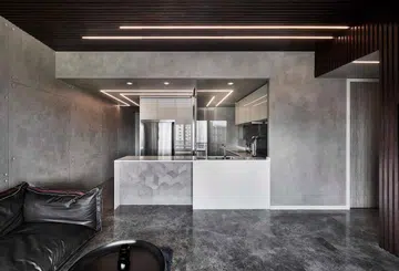 Concrete kitchen island in this all black and white 1,184 sq ft 4-bedroom condo in Queenstown.