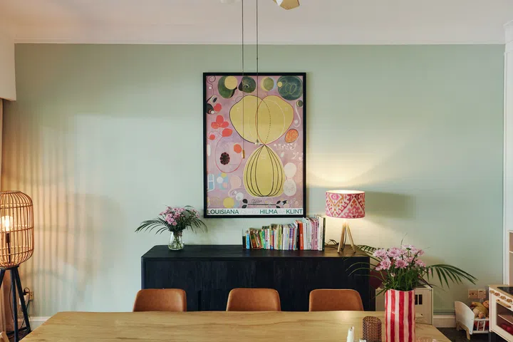 A large lilac artwork draws the eye in the dining area, reflecting the family’s preference for collecting pieces gradually  over time rather than decorating an entire room at once.