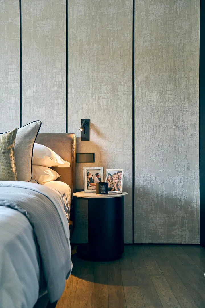  Upholstered wall panels frame the bed, bringing both warmth and a tailored finish to the retreat.
