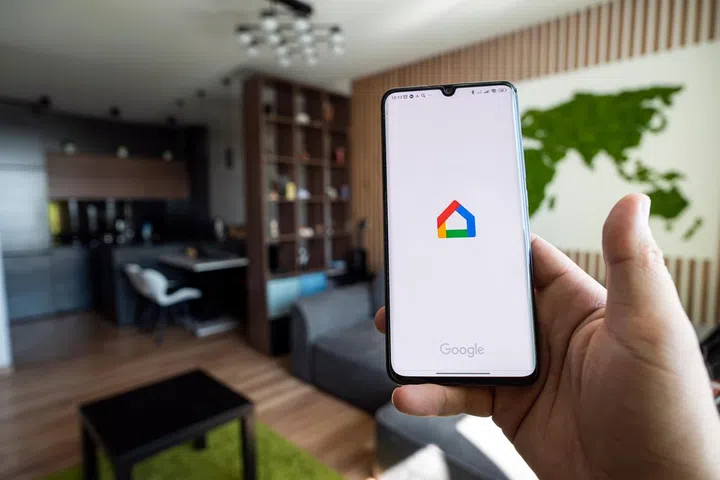 Barnaul. Russia. June 21, 2022: Google home smart control of light and heating in the apartment through the app on smartphone.
